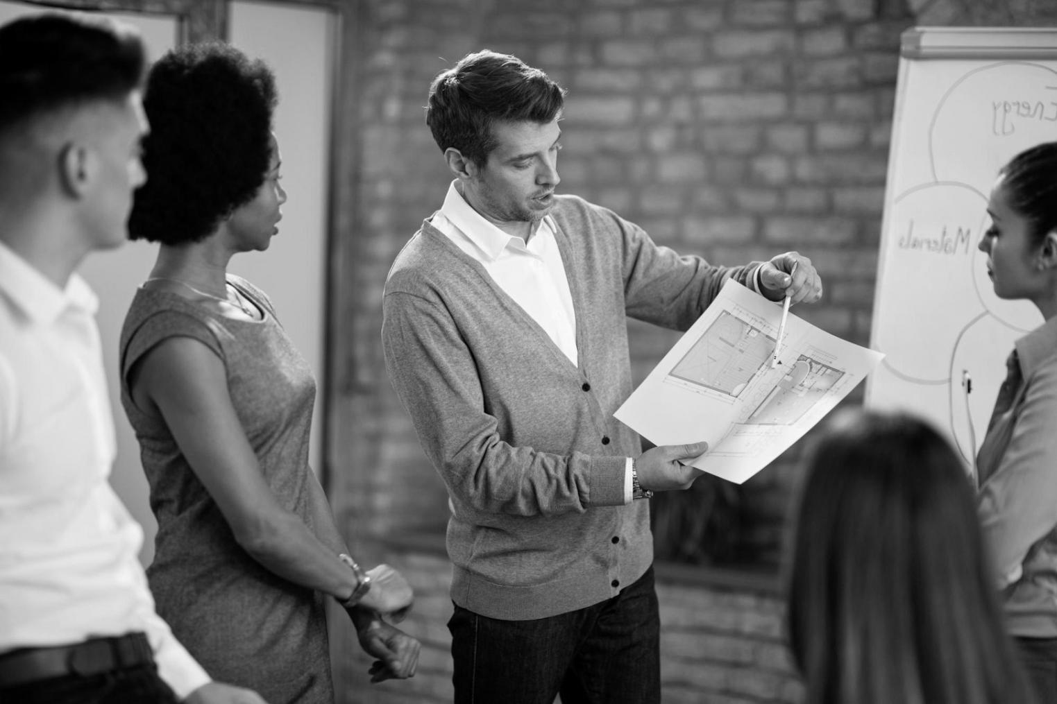 Professional team collaborating on financial analysis in modern office environment